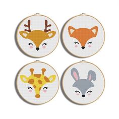 four cross stitch hoops with animals on them