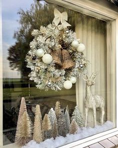 a christmas wreath is hanging in the window