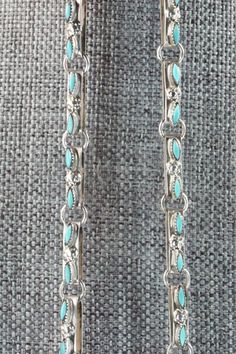 This Kingman turquoise and sterling silver necklace, earrings, bracelets, and rings set was made by Zuni silversmith Merlinda Chavez. The back of the necklace is signed D & M Chavez and Zuni.Necklace: 30"Length: 3 1/2"Width: 2 1/2"Earrings:Length: 1 3/4"Width: 1 3/4"Bracelets:Size: 5 3/4" (will fit up to a 7 1/8" wrist)Gap: 1 3/8"Length: 2 5/8"Rings:Size: 9.25 & 9.5Length: 1 3/4"Width: 1 3/4"Free shipping on all orders! We ship with USPS and always include tracking. All orders ship within a day Silver Jewelry Set, Bracelets And Rings, 2 Earrings, Silver Jewellery Sets, Rings Set, Kingman Turquoise, Native American Jewelry, Sterling Silver Necklace, Turquoise Sterling Silver