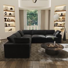 a living room filled with black furniture and lots of bookshelves on the wall