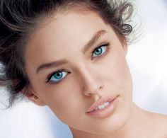 a beautiful young woman with blue eyes posing for the camera