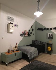 a bedroom with a bed and dresser in it