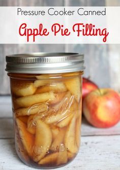 an apple pie filling in a mason jar with apples behind it and text overlay reading pressure cooker canned apple pie filling