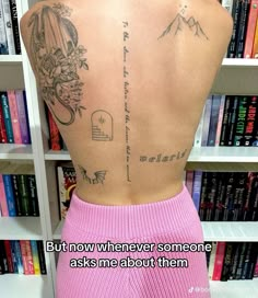 the back of a woman's body with tattoos on it