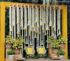 an outdoor ceremony setup with flowers and candles on the stage, surrounded by greenery