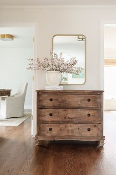 a wooden dresser sitting in the middle of a living room