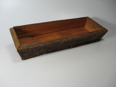 an old wooden box sitting on top of a white table