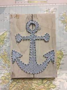 an anchor made out of string on top of a map