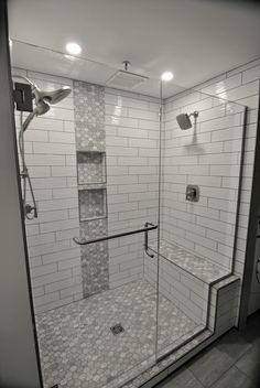 a walk in shower sitting inside of a bathroom next to a tiled wall and floor