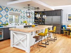 an open concept kitchen and dining room with island in the center, painted blue and yellow