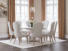 a dining room table with white chairs around it