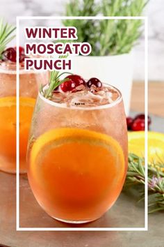 winter moscato punch with cranberries and rosemary garnish in wine glasses