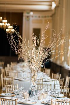 the table is set with white plates and silverware for an elegant wedding reception at the grand america hotel