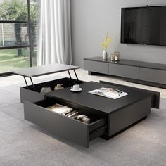 a living room with a coffee table and entertainment center in the middle, on top of carpeted flooring