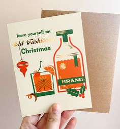 someone holding up a christmas card that says, have yourself an old fashioned christmas brandy