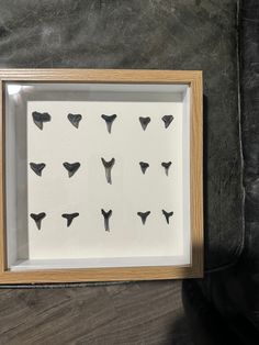 a wooden frame with some black and white animal heads on it