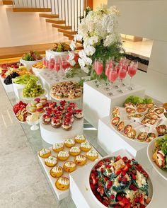 a table filled with lots of different types of desserts and cupcakes on it