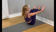 a woman is sitting on the floor doing yoga