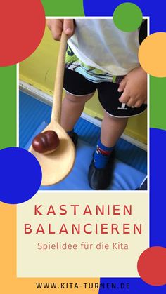 a young child holding a wooden spoon in front of a poster with polka dots on it