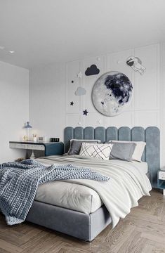 a bedroom with white walls and wood flooring is decorated in shades of blue, grey and white