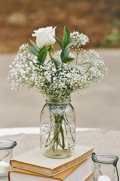 a vase filled with white flowers sitting on top of a table