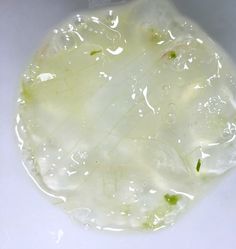 a white bowl filled with liquid and vegetables