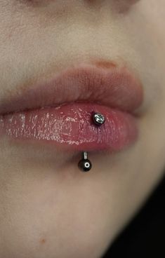 a woman with a piercing on her lip is shown in close up view from the side