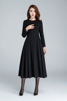 "This Long black dress design with midi length, match a black heel, make you more slim and high. This wool dress design with a smaller collar, so it open by back zipper, so that your head can through easily. This winter dress is warm in cold winter. it has a polyester lining, so don't need worry not comfortable. Details: * Made from black wool * 35% wool blend, 35% fiber and polyester, 30% nylon * Polyester lining * Big Round neckline * No pockets * Back zip closure * Long sleeve * Below the kne