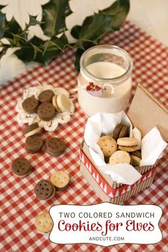 two colored sandwhich cookies for elves are on the table next to a jar of milk