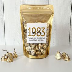 a bag of gold foiled chocolates next to it's contents