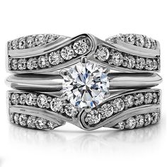 a wedding ring set with a round diamond in the center and two rows of diamonds on each band