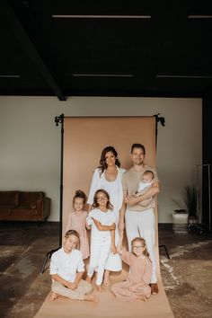 a family posing for a photo in front of a backdrop