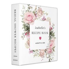 a recipe book with pink roses and greenery on the cover, in front of a white background