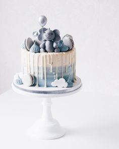 there is a cake decorated with elephants on top of it and icing dripping down the side