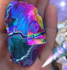 a person holding a colorful rock in their hand