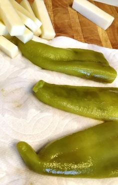 some green peppers and cheese on a cutting board