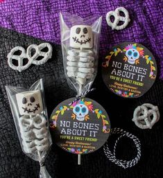 some kind of candy with skeleton decorations on it, and two lollipops in the shape of skulls