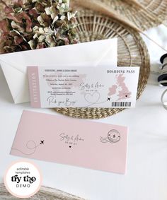 the wedding stationery is in pink and white, with an envelope that says boarding pass