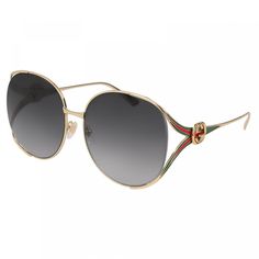 Introducing the exquisite Gucci GG0225S 001 Gold/Grey sunglasses, a stunning piece from the iconic fashion house Gucci. This luxurious eyewear is designed for the modern and stylish woman who appreciates high-quality craftsmanship and chic design. The frame of the GG0225S is made from premium metal in a glamorous gold finish, adding a touch of sophistication to any outfit. The round shape of the lenses exudes a classic elegance, making them a timeless addition to your accessory collection. The lens color in a sleek grey tone complements the gold frame beautifully, creating a harmonious and stylish look. With a lens socket width of 63 and a bridge size of 17, these sunglasses are designed to provide a comfortable fit for all-day wear. The temple length of 130 adds an extra level of comfort Black Gold Sunglasses, Gucci Eyeglasses, Christian Dior Sunglasses, Dolce Gabbana Sunglasses, Grey Sunglasses, Gucci Eyewear, Dior Sunglasses, Buy Gucci, Men Eyeglasses