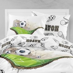 a bed with soccer themed sheets and pillows