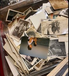 a pile of old photographs and pictures in a case