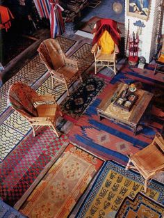 a living room filled with lots of furniture and rugs