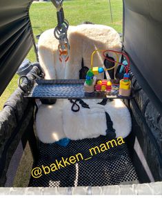 the back end of a vehicle with various items in it and a keychain hanging from the side