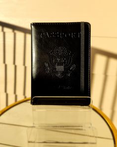 Travel in luxurious style with this chic passport holder. Crafted with the globe-trotter in mind, it's designed to make traversing the world easier and more stylish than ever before. Its sophisticated hue and polished finish elevate your travels, helping you make a statement no matter where you go. Black Travel Accessories With Card Slots, Luxury Black Card Holder For Travel, Luxury Bifold Card Holder For Travel, Modern Black Card Holder For Travel, Elegant Bifold Card Holder For Travel, Elegant Bifold Travel Card Holder, Black Portable Card Holder For Travel, Portable Black Card Holder For Travel, New Passport