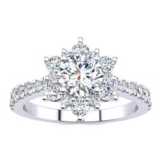 a white gold engagement ring with an intricate flower design and round brilliant diamonds on the band