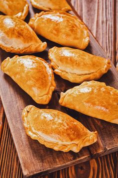 several pieces of pie on a wooden tray