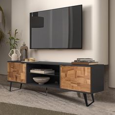 an entertainment center with a flat screen tv mounted on it's sideboard, in a living room