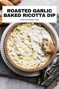 roasted garlic baked ricotta dip in a bowl with bread and herbs on the side