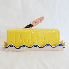 a yellow butter container sitting on top of a white table