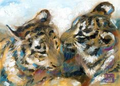 two tiger cubs laying down on the ground in front of blue and yellow sky with white clouds